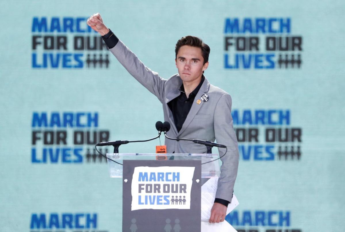 FILE PHOTO  David Hogg  a student at the Marjory Stoneman Douglas High School  site of a February mass shooting which left 17 people dead in Parkland  Florida  thrusts his fist in the air as he speaks during the  March for Our Lives  event demanding gun control after recent school shootings at a rally in Washington  U S   March 24  2018  REUTERS Aaron P  Bernstein File Photo