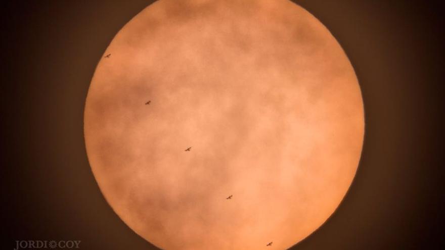 La Estación Espacial Internacional en su tránsito por el Sol en una secuencia de cinco imágenes.