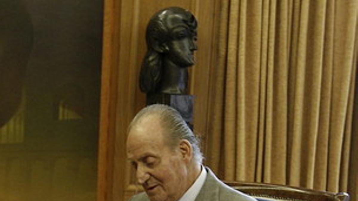 El Rey hojea la memoria del Tribunal Constitucional correspondiente al 2011, el pasado jueves, en la Zarzuela.