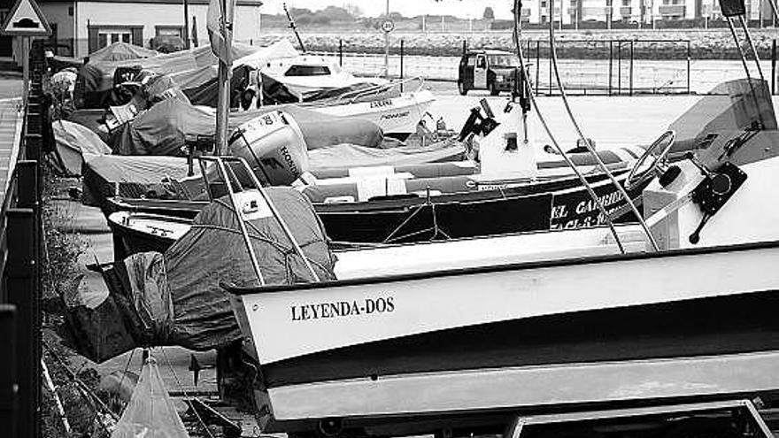 Unas embarcaciones, esperando amarre en el puerto de San Esteban.