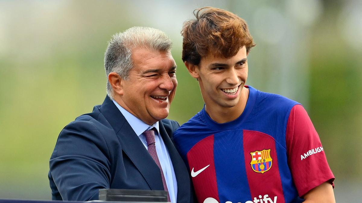 Portuguese forward Joao Felix (R) shakes hands with FC Barcelona president Joan Laporta during his official presentation as new player of FC Barcelona at the Joan Gamper training ground in Sant Joan Despi, near Barcelona, on September 2, 2023. Barcelona signed Atletico Madrid forward Joao Felix and Manchester City defender Joao Cancelo on loan until the end of the season. (Photo by Pau BARRENA / AFP)