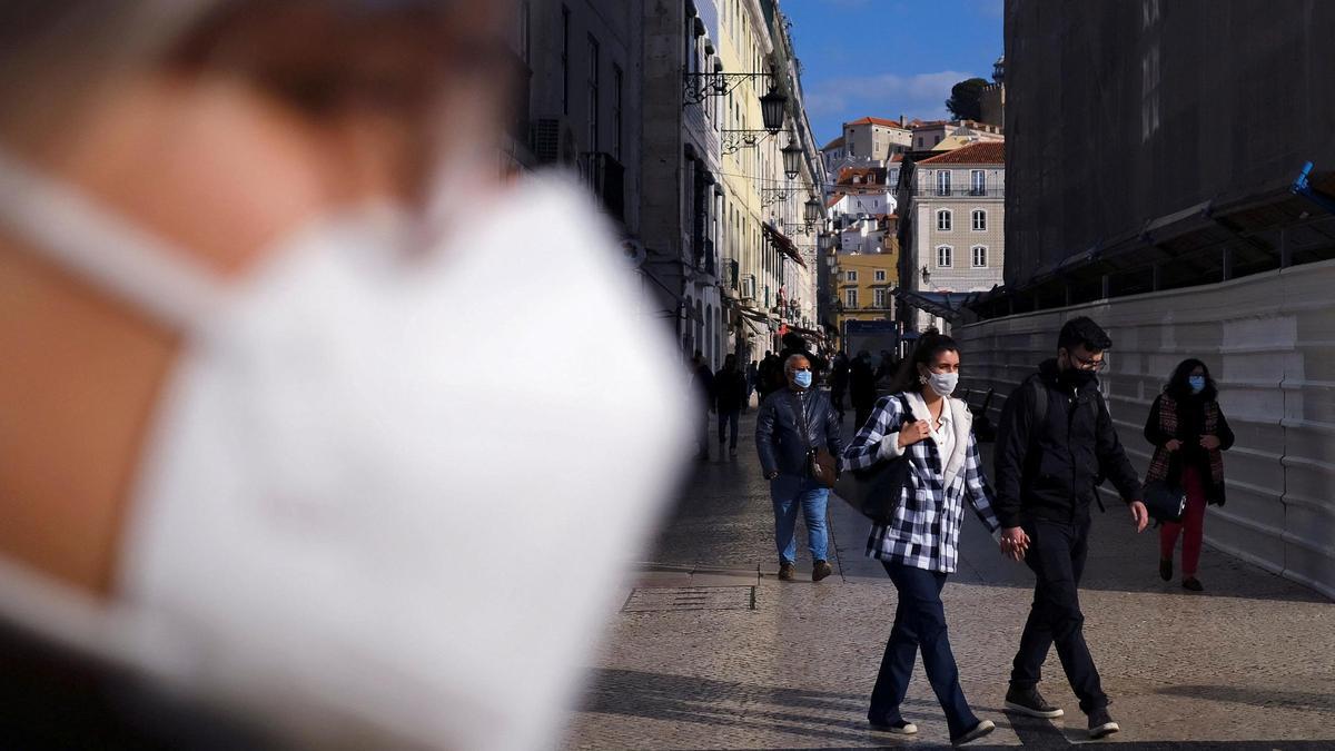 People wear protective masks amid the coronavirus disease (COVID-19) pandemic in Lisbon