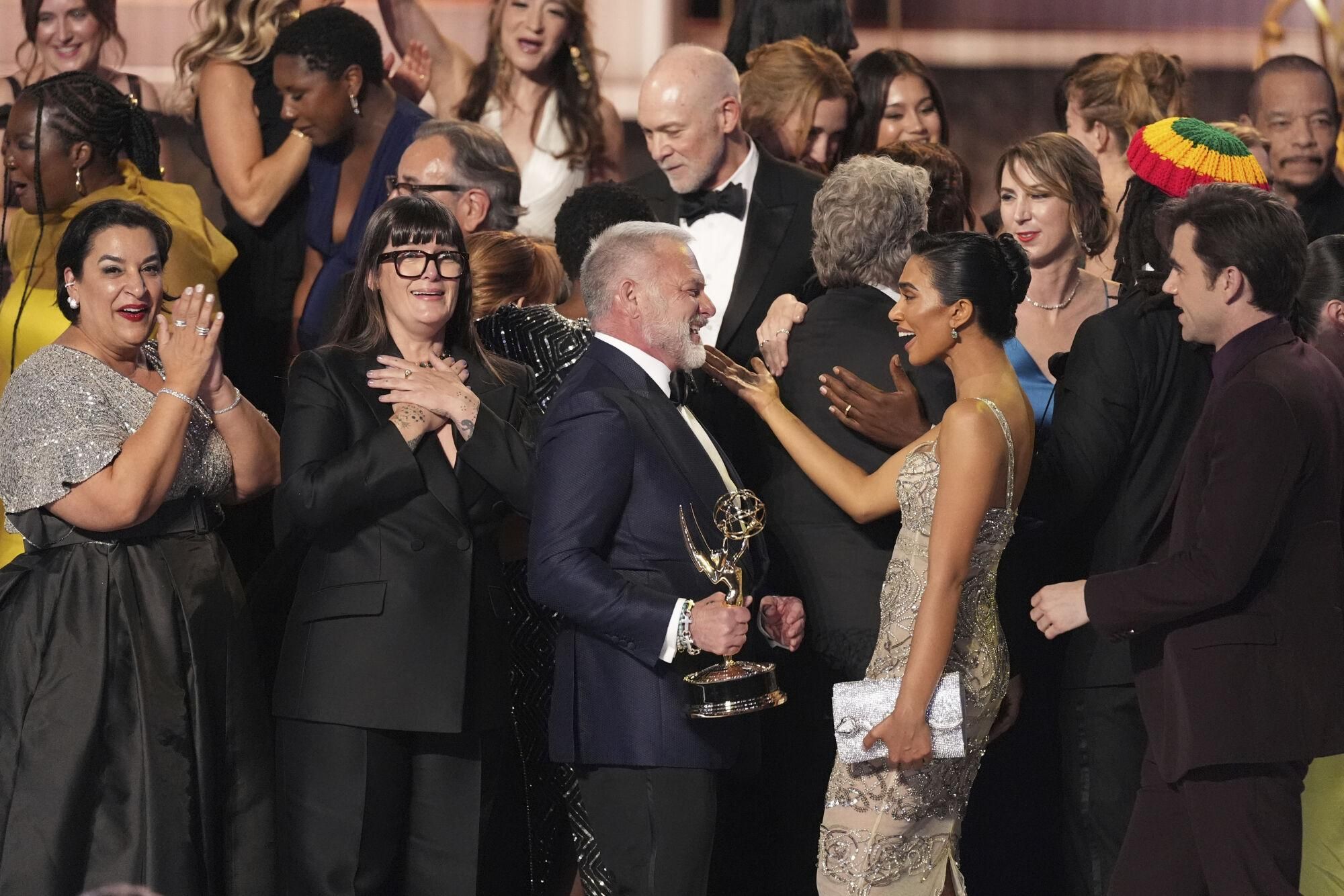 R. Scott Gemmill, center, and the cast and crew of "The Pitt" accept the award for outstanding drama series during the 77th Primetime Emmy Awards on Sunday, Sept. 14, 2025, at the Peacock Theater in Los Angeles. (AP Photo/Chris Pizzello). 091425132020, 21334631,