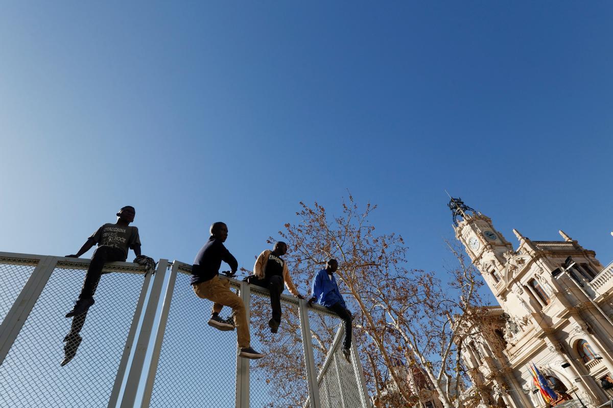 Ninots or giant figures depicting migrants jumping a fence are displayed in the streets before being burned during the traditional annual Fallas festival, in Valencia, Spain, March 15, 2024. REUTERS/Eva Manez