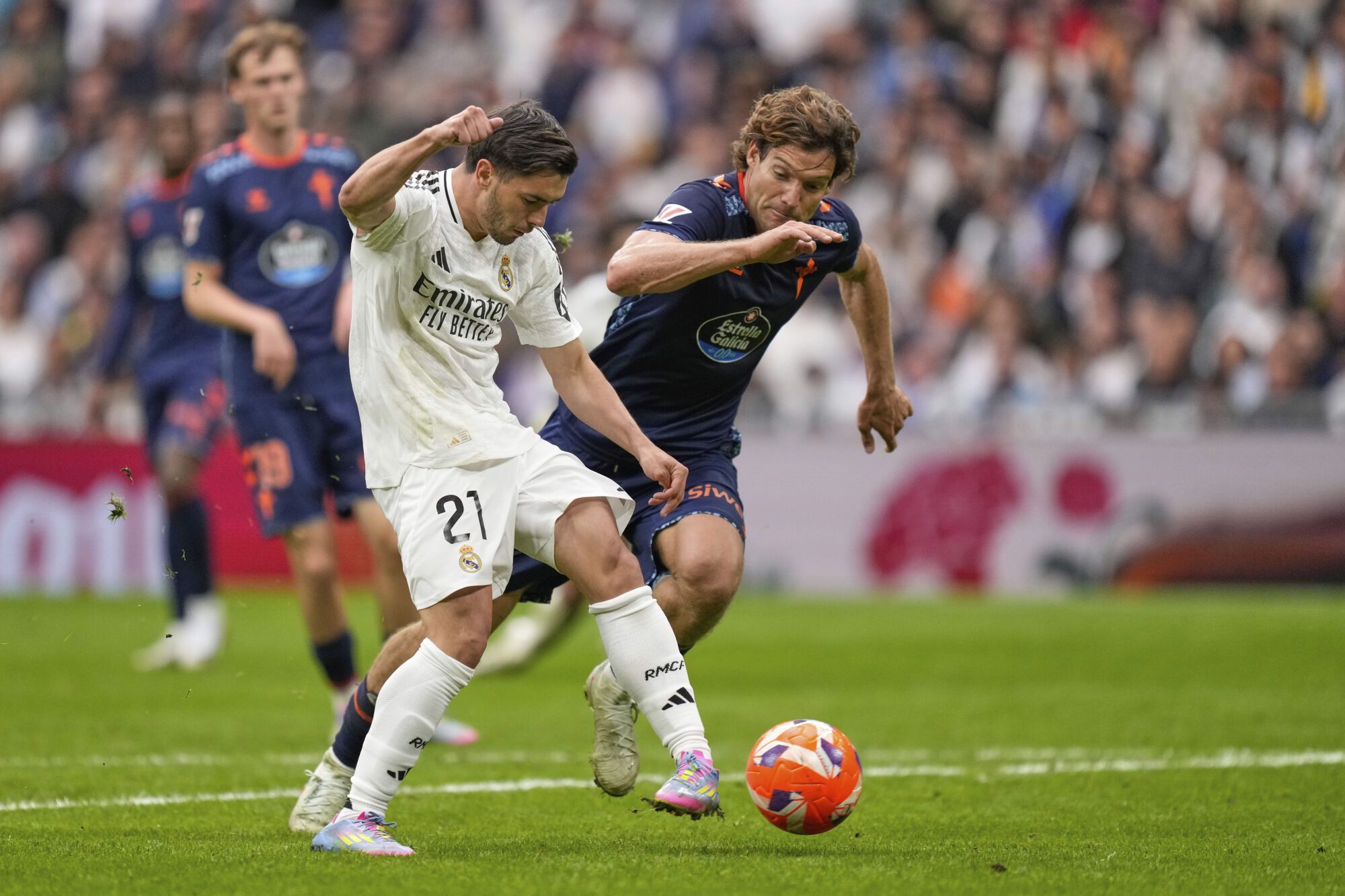 Real Madrid's Brahim Diaz, left, kicks the ball ahead of Celta's Marcos Alonso during the Spanish La Liga soccer match between Real Madrid and Celta Vigo at the Santiago Bernabeu stadium in Madrid, Spain, Sunday, May 4, 2025. (AP Photo/Jose Breton)