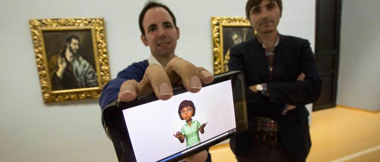 Javier Gutiérrez, de Treelogic, y Alfonso Palacio, director del Museo de Bellas Artes, en la sala del Apostolado del Greco, con el &quot;avatar&quot; de la guía para personas con problemas auditivos.