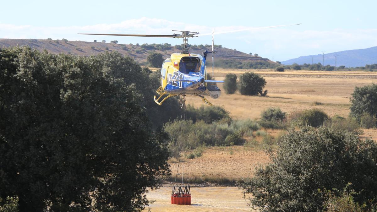 Un helicóptero carga agua para apagar el incendio en San Vicente de la Cabeza