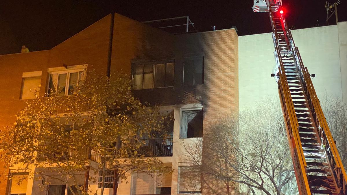 Los bomberos, durante la extinción del fuego anoche en la calle Alfons el Magnànim.