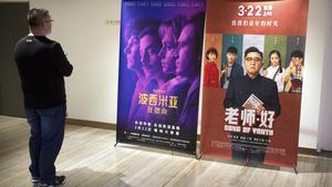 Un cliente de un cine chino observa un cartel de la película ’Bohemian Rhapsody’ en Pekín.  