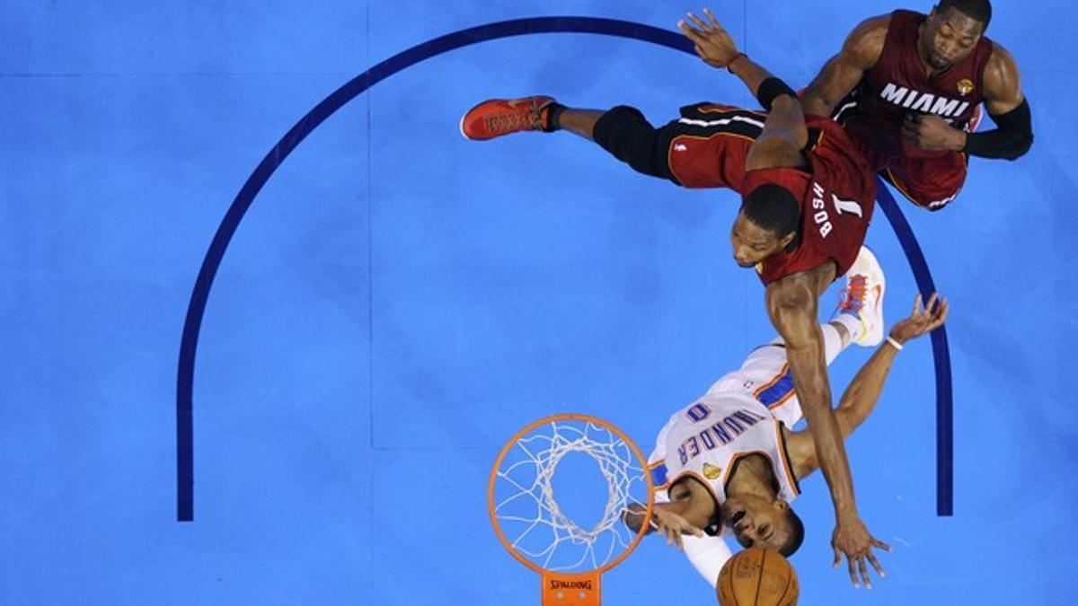 Russel Westbrook, de Oklahoma, lucha contra Chris Bosh y Dwyane Wade de los Miami Heat durante la final de la NBA