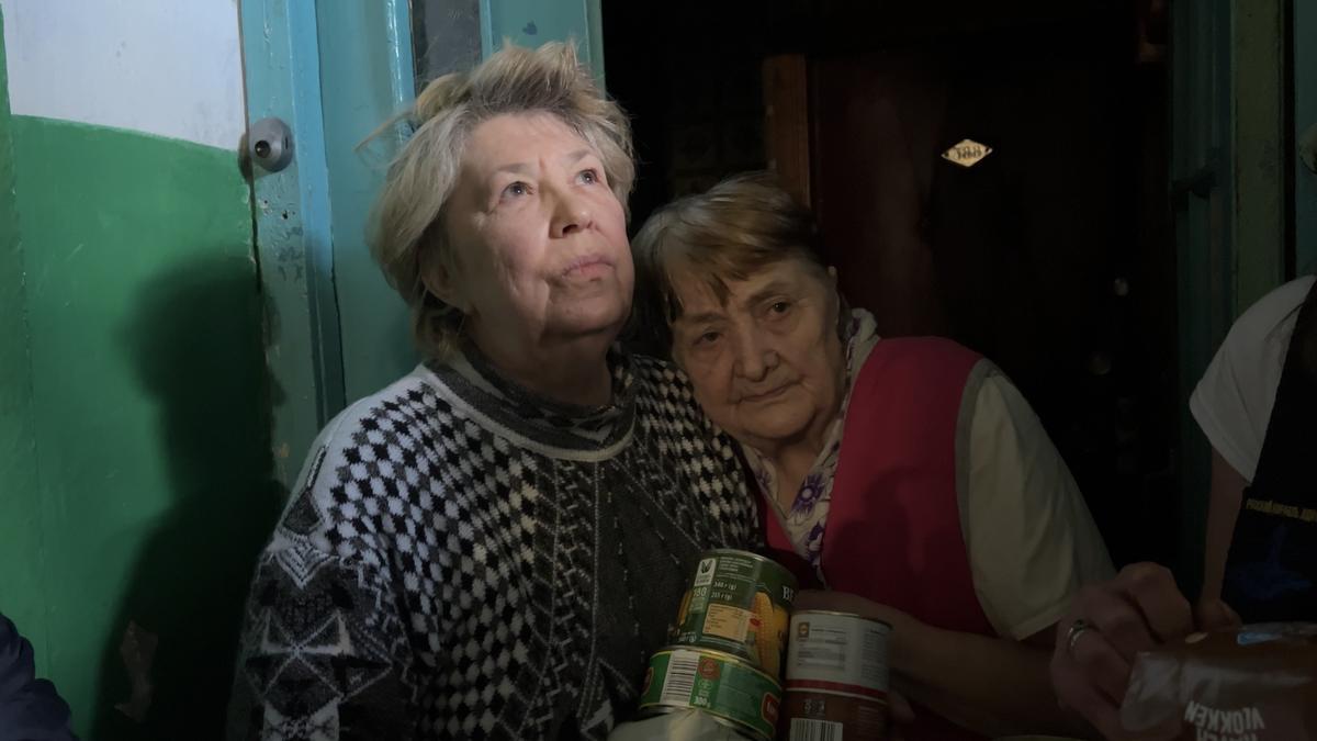 Dos mujeres reciben ayuda de voluntarios en Járkov (Ucrania).