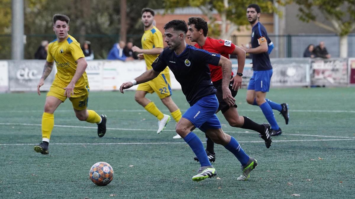 L'interior del FC Joanenc Gerard Martínez intenta aturar la conducció del ‘maurista’ Jordi Aribau