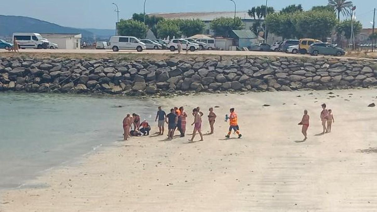 Momento en el que la señora está siendo atendida en la orilla, tras ser rescatada del agua.