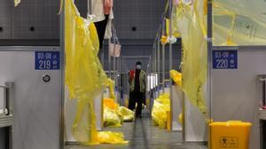 Un hombre camina entre camillas en un hospital temporal para positivos de covid en Shanghái, este lunes.