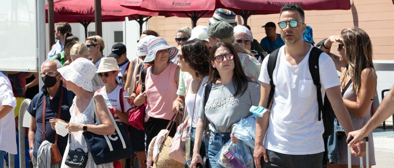 Turistas llegados en crucero esperando un taxi en Ibiza.