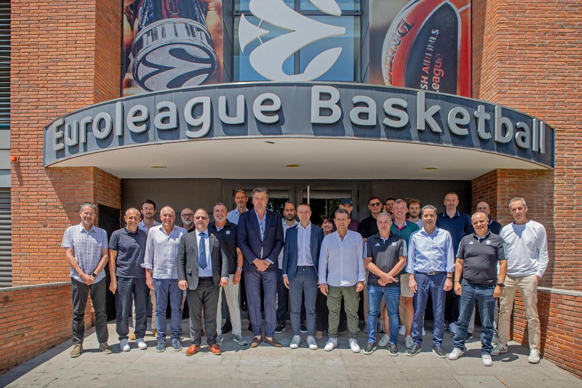 Euroleague technicians pose at the entrance of the Euroleague headquarters in Barcelona
