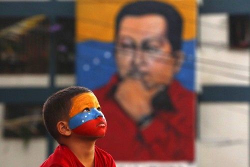 A young supporter of of Venezuela's late president Hugo Chavez stands outside the mausoleum during the first anniversary of his death in Caracas
