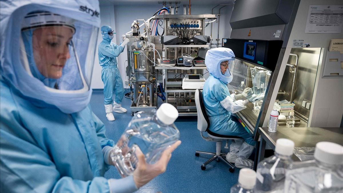 CORRECTION   Embargoed until March 30  2021 - 22 01 GMT   Employees in cleanroom suits test the procedures for the manufacturing of the messenger RNA (mRNA) for the Covid-19 vaccine at the new manufacturing site of German company BioNTech on March 27  2021 in Marburg  central Germany  - German firm BioNTech said on March 30  2021 it was on track to manufacture 2 5 billion doses of its Covid-19 vaccine this year with US partner Pfizer  25 percent more than previously expected  (Photo by Thomas Lohnes   AFP)    The erroneous mention s  appearing in the metadata of this photo by Thomas Lohnes has been modified in AFP systems in the following manner   ---  instead of  ---   Please immediately remove the erroneous mention s  from all your online services and delete it (them) from your servers  If you have been authorized by AFP to distribute it (them) to third parties  please ensure that the same actions are carried out by them  Failure to promptly comply with these instructions will entail liability on your part for any continued or post notification usage  Therefore we thank you very much for all your attention and prompt action  We are sorry for the inconvenience this notification may cause and remain at your disposal for any further information you may require