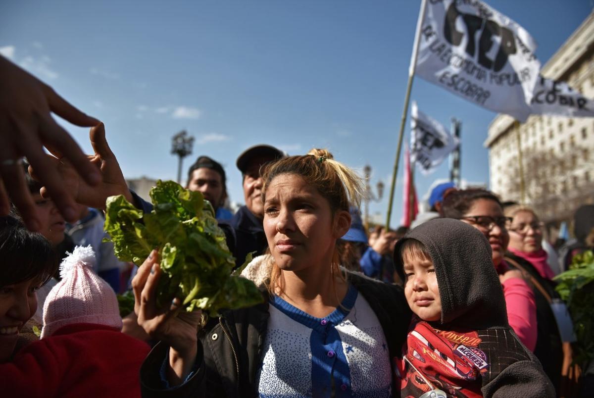 People receive free vegetables while protesting social conditions during the day of Saint Cajetan  the patron saint of Argentina and labour  in Buenos Aires  Argentina August 7  2019  REUTERS Pablo Stefanec NO RESALES  NO ARCHIVES