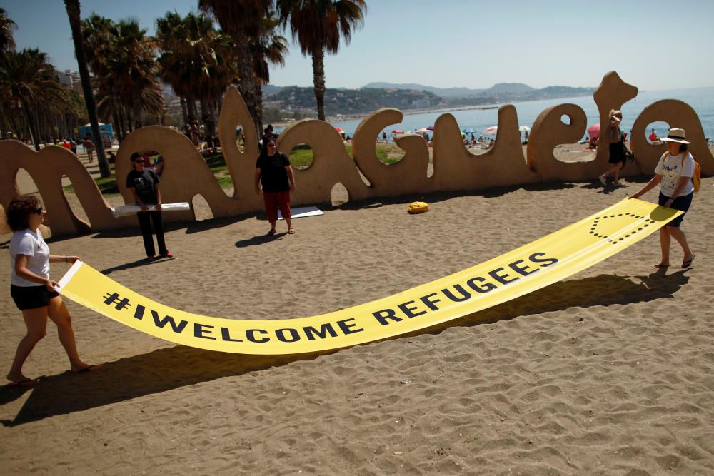 Activists from Amnesty International place a ...