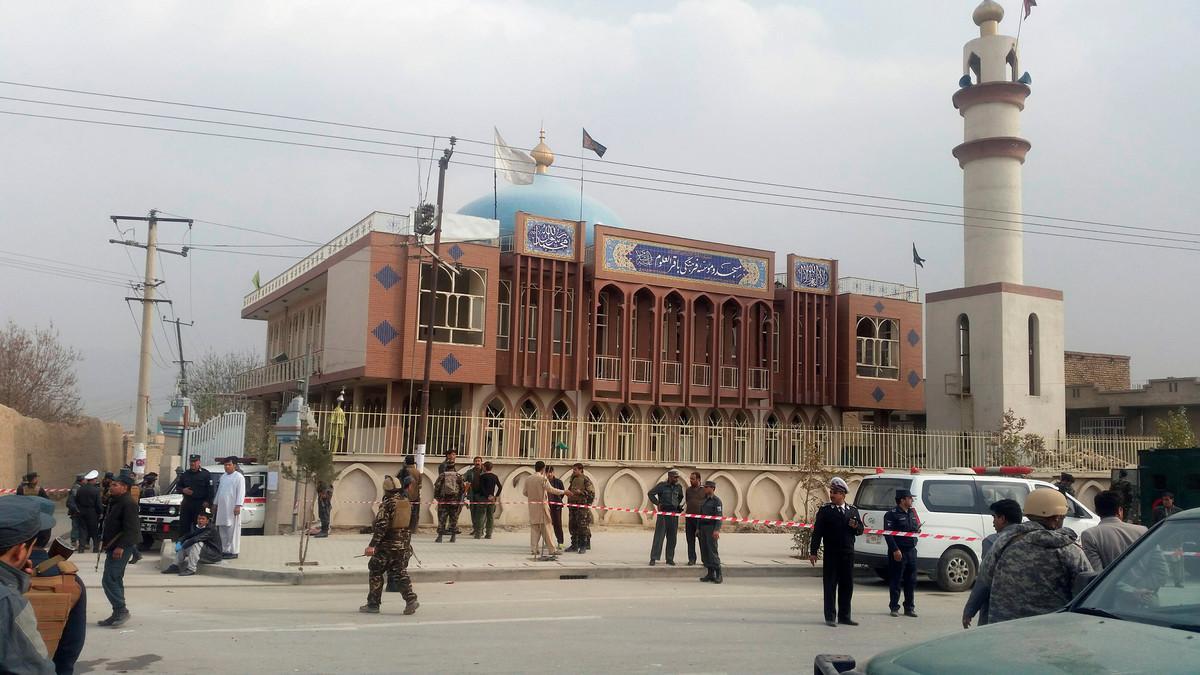 Afghan security forces keep watch in front of a mosque where an explosion happened in Kabul, Afghanistan