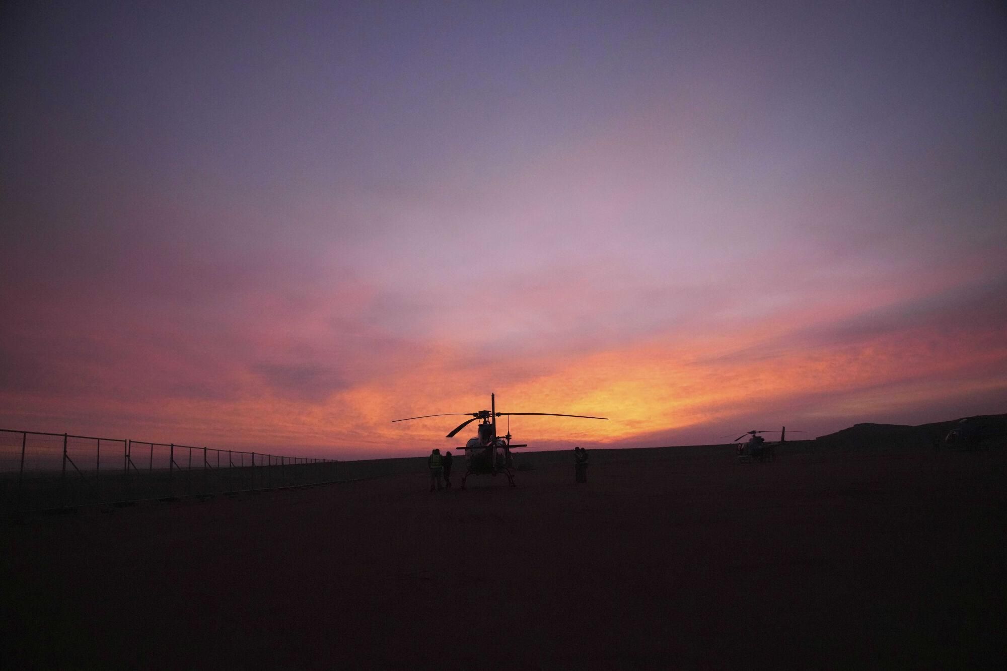 An organization helicopter is pictured before the fifth stage of the Dakar Rally between Alula and Hail, Saudi Arabia, Thursday, Jan. 9, 2025. (AP Photo/Christophe Ena). EDITORIAL USE ONLY / ONLY ITALY AND SPAIN