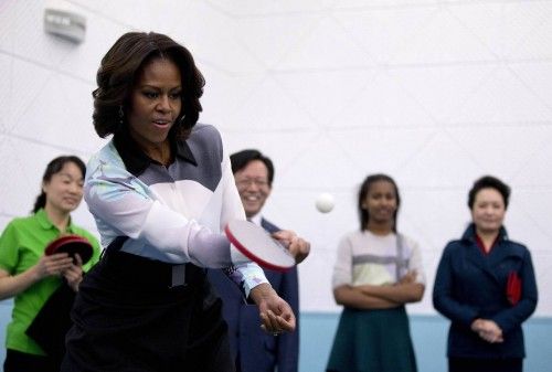 U.S. first lady Michelle Obama plays table tennis during her visit of Beijing Normal School
