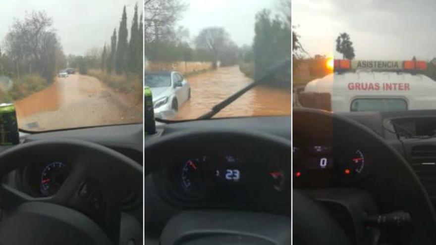 Un conductor intenta cruzar un camino inundado en El Puig... y se atasca