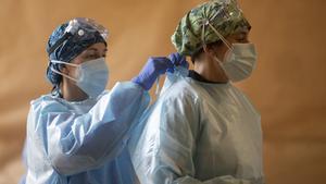 Una trabajadora sanitaria ayuda a un compañero en un dispositivo de cribado masivo de antígenos organizado para detectar positivos por coronavirus en Alcorcón, Madrid, el 11 de febrero de 2021.
