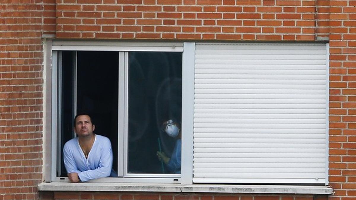 Javier Limón, marido de Teresa Romero, mira a través de la ventana de su habitación.