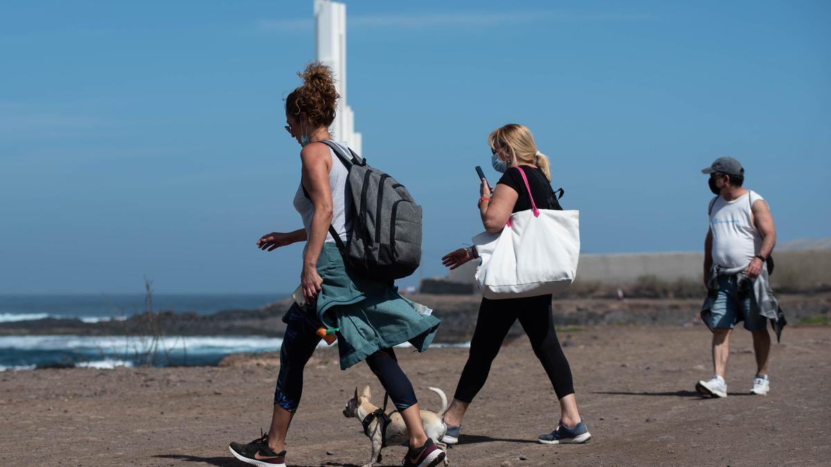 Varias personas caminan por el paseo del litoral de Punta dle Hidalgo