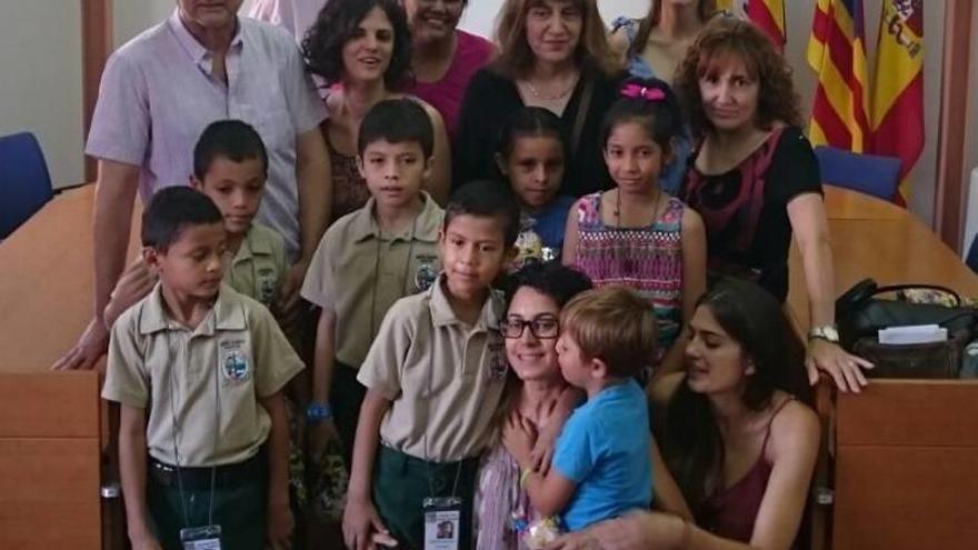 Miembros del consistorio con los niños y las familias de acogida.