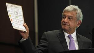 Andres Manuel Lopez Obrador  presidential candidate for the Party of the Democratic Revolution  PRD   shows a ballot during a news conference in Mexico city July 12  2012 The runner-up in Mexico s presidential election said on Thursday he will ask the country s electoral tribunal to void the results  arguing that the winner broke campaign finance laws to buy votes  Lopez Obrador came in 3 3 million votes behind Enrique Pena Nieto from the centrist Institutional Revolutionary Party  PRI   according to the official count from the July 1 vote  REUTERS Edgard Garrido  MEXICO - Tags  POLITICS ELECTIONS