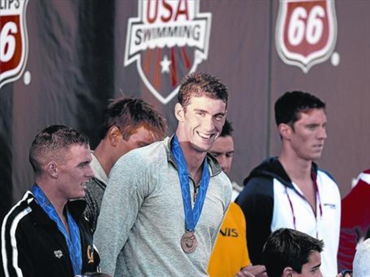 Michael Phelps somriu al rebre una medalla pel seu setè lloc en els 100 lliure a Irvine (Califòrnia).