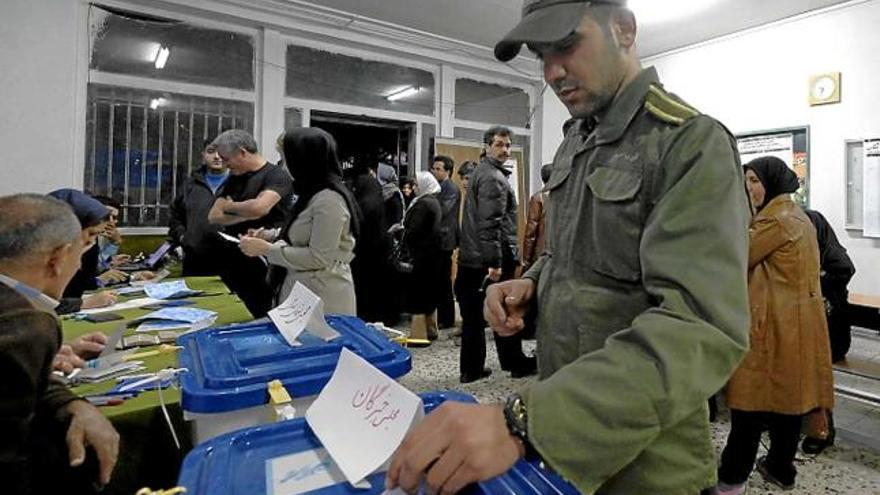 Un policia iranià exercint el dret a vot en les eleccions de divendres