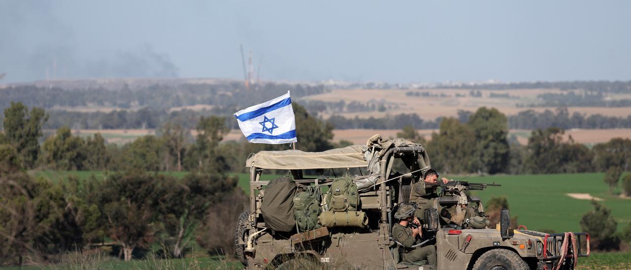 Israeli soldiers patrol along the border with Gaza