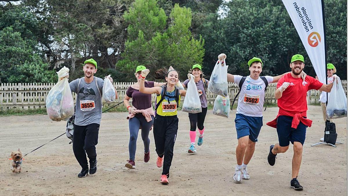 Participantes en la jornada muestran las bolsas de basura que han recogido. |  PLOGGING TOUR