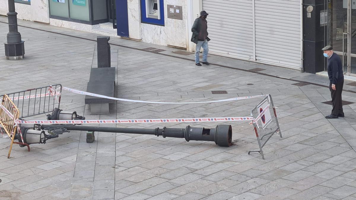 Un hombre observa la farola, justo antes de que se la llevaran.