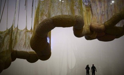 Visitors stand under "Life Is A Body We Are Part Of", a giant biomorphic sculpture that forms part of a retrospective of the work of Brazilian artist Ernesto Neto, at the Guggenheim Museum in Bilbao