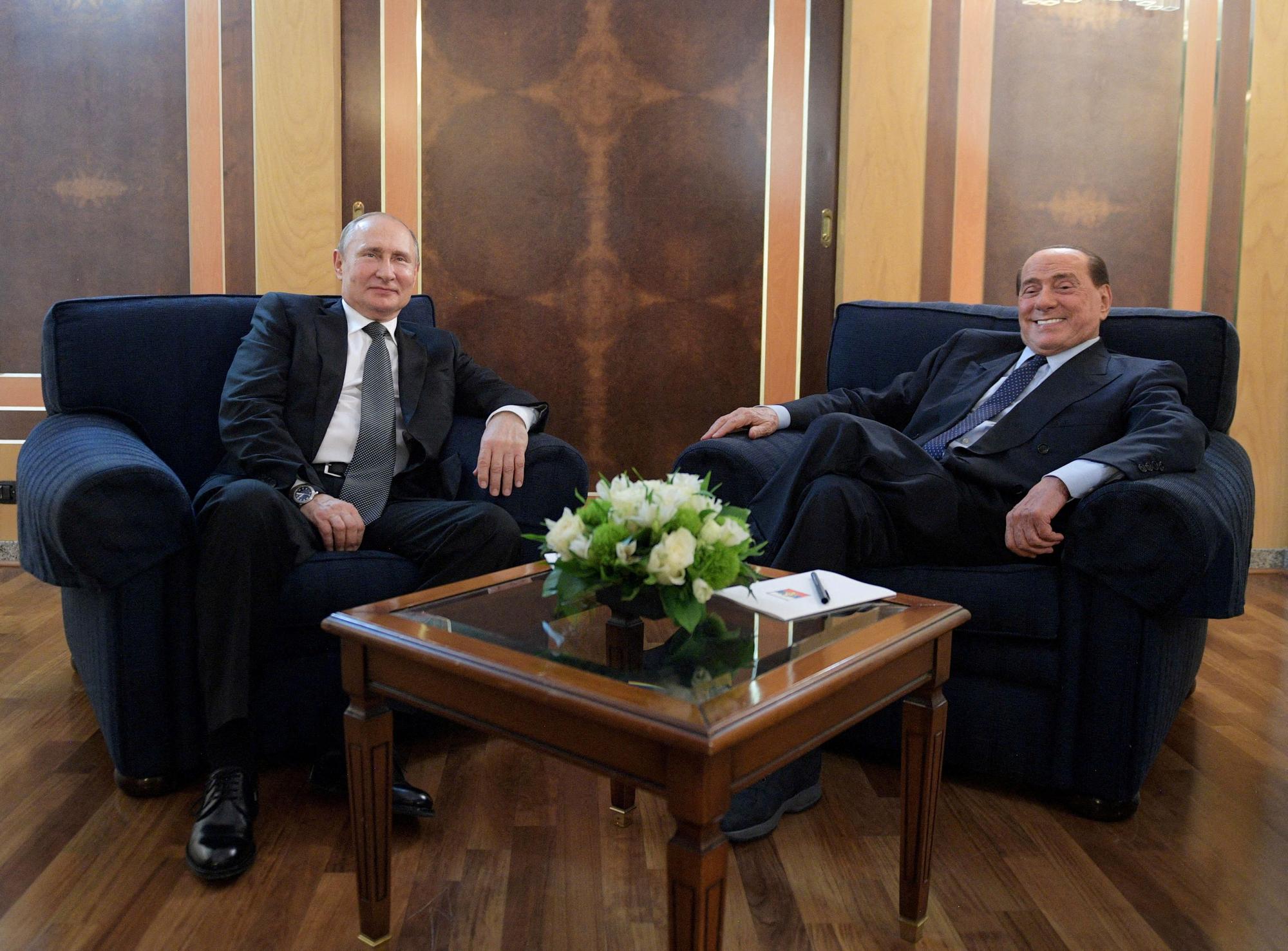 Russian President Vladimir Putin meets with Silvio Berlusconi at an airport in Rome, Italy July 4, 2019.
