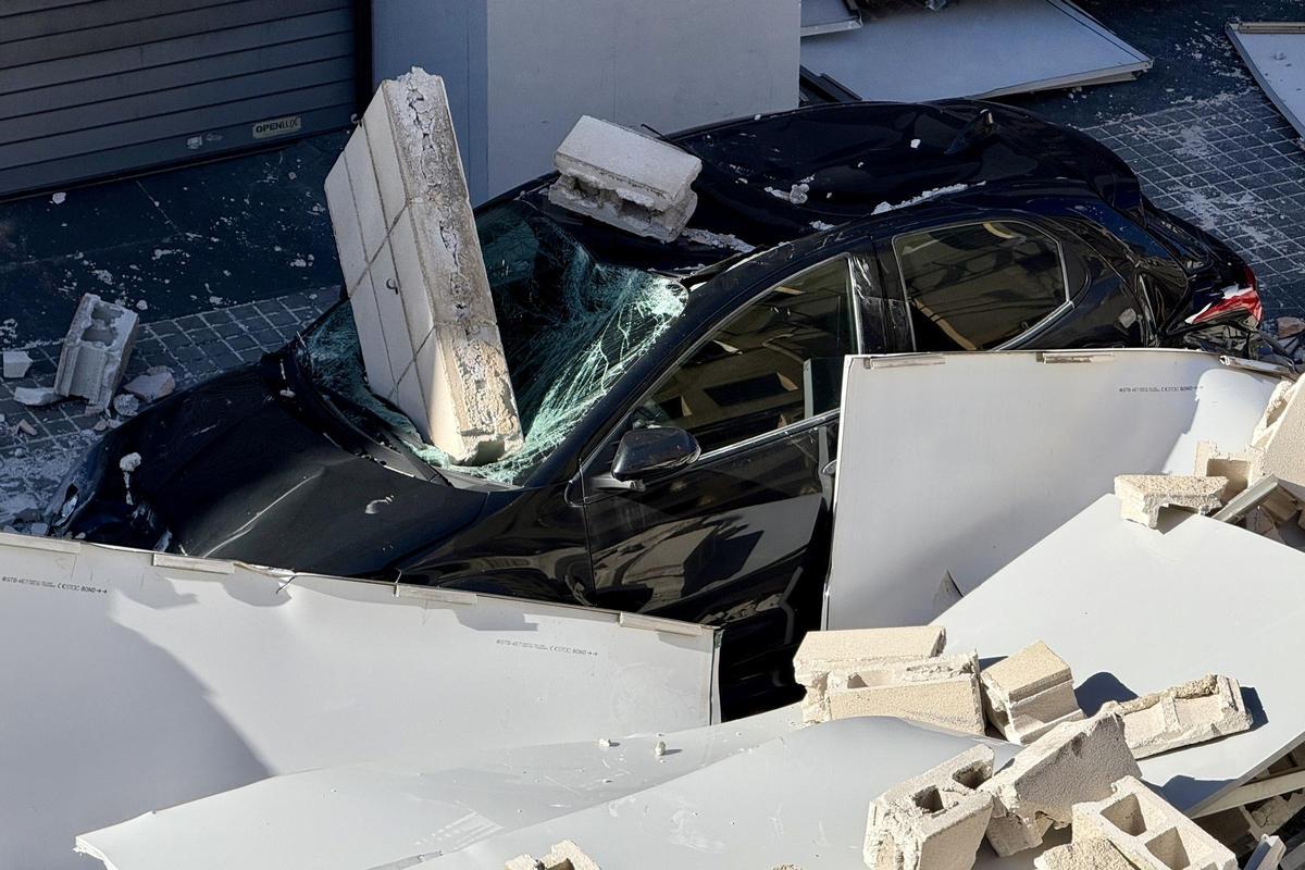 Cotxe on hi havia la dona ferida lleu després de la caiguda d'una coberta i un mur d'un taller a l'Hospitalet de Llobregat.