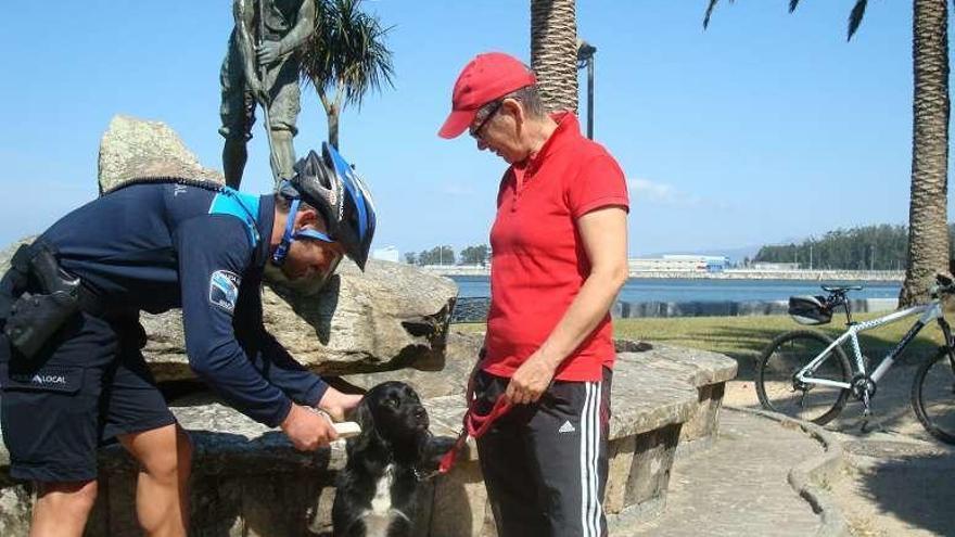 Un agente realiza un control de microchip en A Calzada. // I.Abella