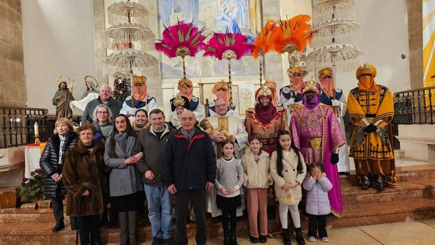 Miembros y colaboradores de la parroquia, varios niños y los Reyes  Magos con sus pajes, ayer, en la iglesia. | V. ALONSO