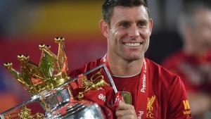 Liverpools English midfielder James Milner poses with the Premier League trophy during the presentation following the English Premier League football match between Liverpool and Chelsea at Anfield in Liverpool, north west England on July 22, 2020. - Liverpool on Wednesday lifted the Premier League trophy at the famous Kop stand at Anfield after their final home game of the season. With no fans able to attend due to the COVID-19 coronavirus pandemic, Liverpool said the idea for the trophy lift was to honour the clubs fans, but Liverpool manager Jurgen Klopp urged fans to respect social distancing measures, after thousands gathered around the clubs stadium and in the city centre following their coronation as champions last month. (Photo by Paul ELLIS / POOL / AFP) / RESTRICTED TO EDITORIAL USE. No use with unauthorized audio, video, data, fixture lists, club/league logos or live services. Online in-match use limited to 120 images. An additional 40 images may be used in extra time. HORIZONTAL
