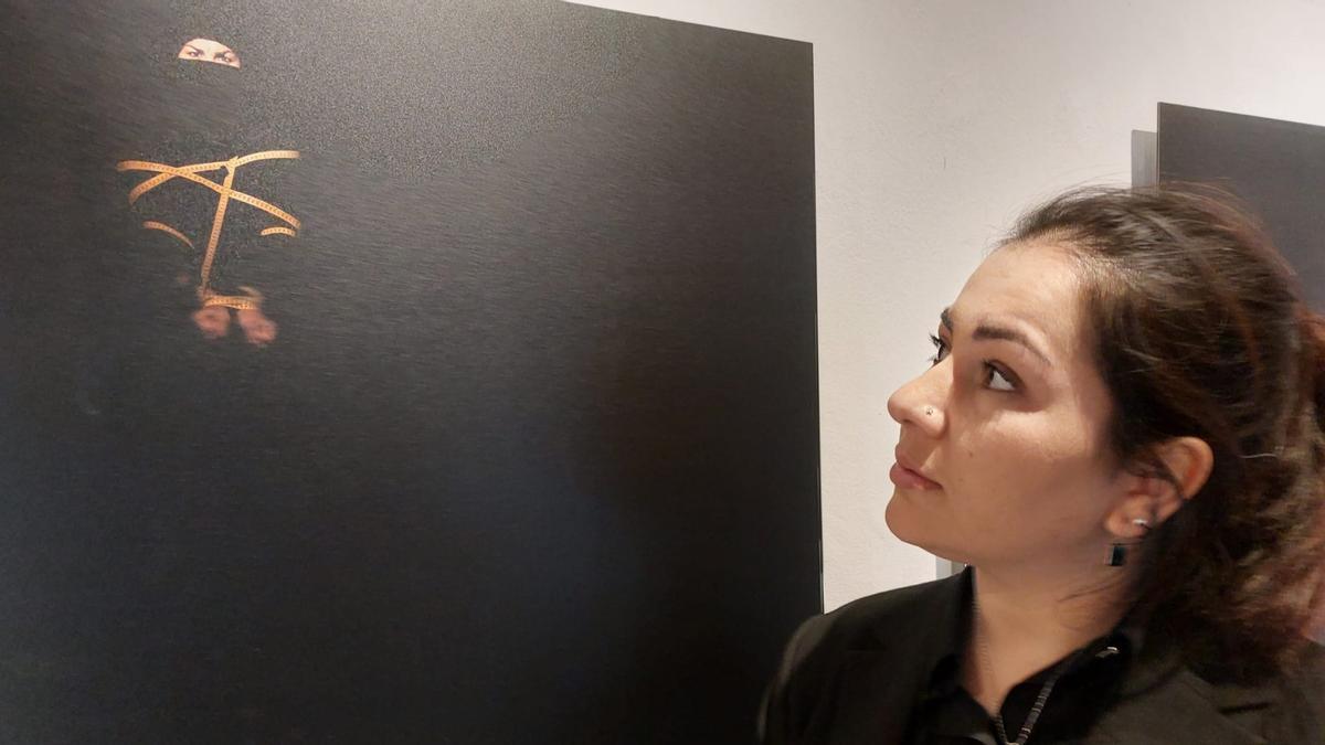 Khadija Amin observa una de las fotografías de la exposición 29miradas, en Segovia, en noviembre de 2022