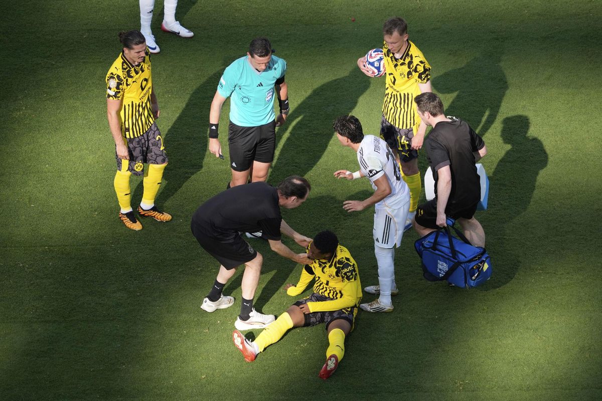 Borussia Dortmunds Julien Duranville, bottom, receives medical treatment during the Club World Cup quarterfinal soccer match between Real Madrid and Borussia Dortmund in East Rutherford, N.J., Saturday, July 5, 2025. (AP Photo/Pamela Smith)