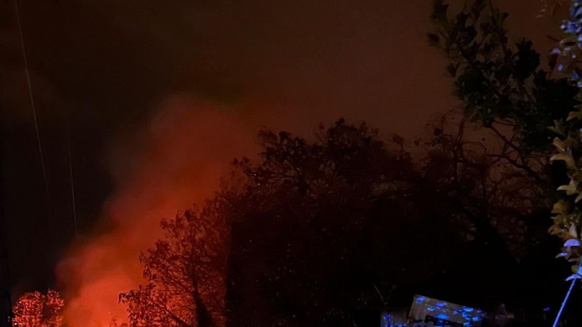 La caseta afectadas y el fuego en el monte.