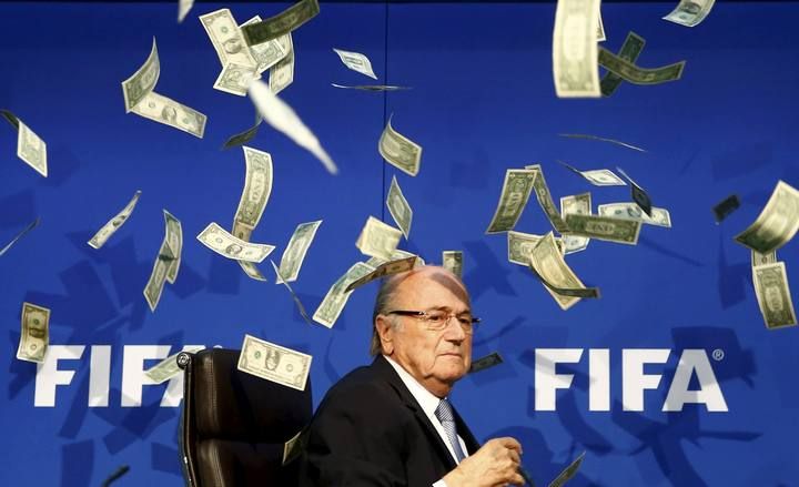 File picture shows banknotes being thrown at FIFA President Blatter as he arrives for a news conference after the Extraordinary FIFA Executive Committee Meeting at the FIFA headquarters in Zurich