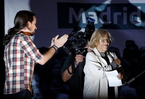 Ahora Madrid local candidate, Carmena, is applauds by Podemos leader Iglesias after the regional and municipal elections in Madrid