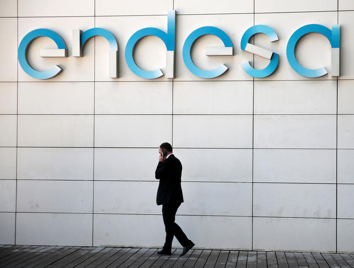 A man walks under the logo of Spanish power company Endesa at their headquarters in Madrid, Spain, April 26, 2016. REUTERS/Andrea Comas